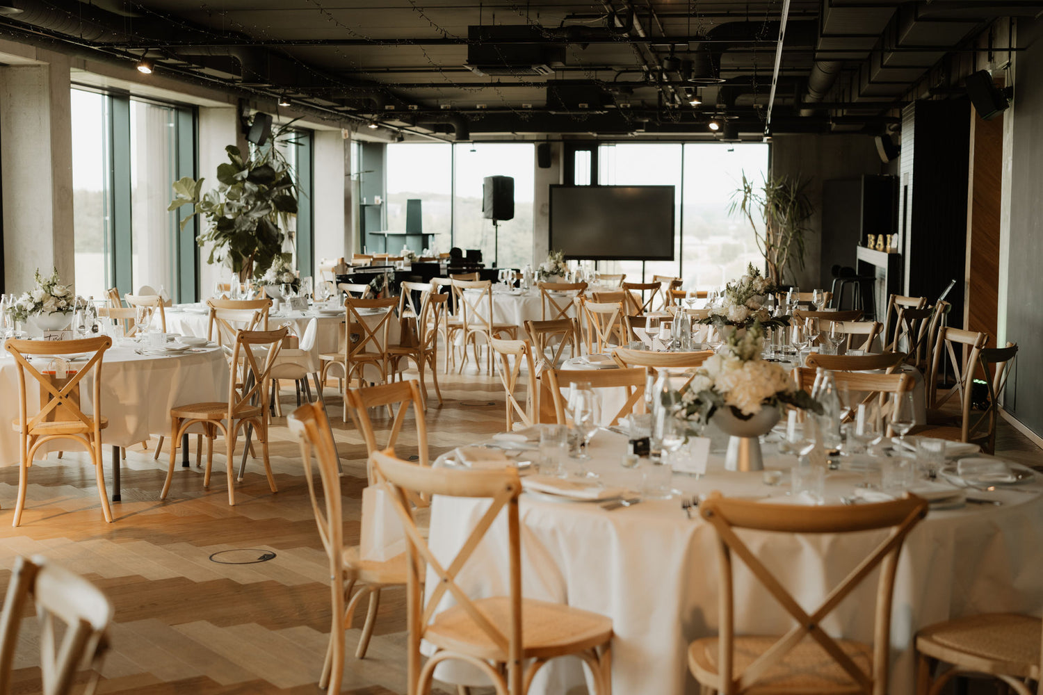 Stage PLICANA mit Holzstühlen und weißen Tischen