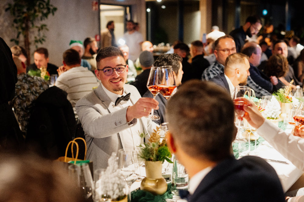STAGE im PLICANA in Kronau Männer im Anzug stoßen an bei Weihnachtsfeier